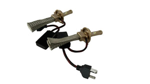 Two spark plugs on a white surface