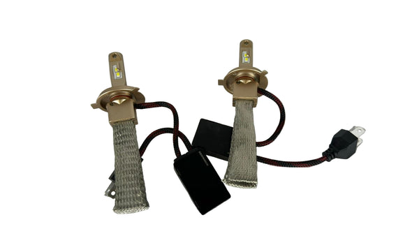 Two car headlight bulbs with connectors on a white background
