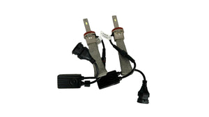 Two car light bulbs with connectors on a white fabric background