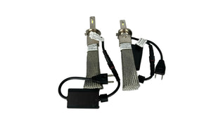 Two automotive light bulbs with connectors on a white background