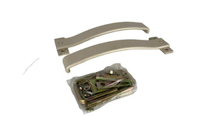 Two beige metal brackets and a package of hardware on a white surface
