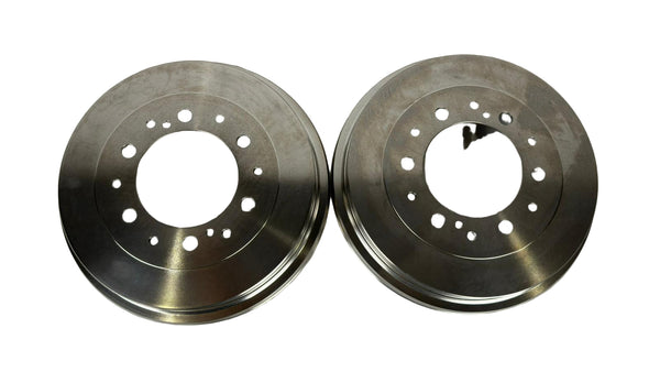 Two metallic brake rotors on a white background