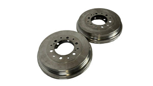 Two metallic brake rotors on a white paper background