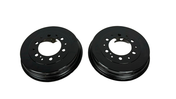 Two black brake rotors on a white background