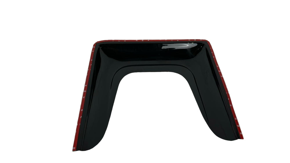 Black car fender with red trim on a white surface